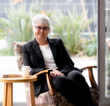 woman sitting in chair by window