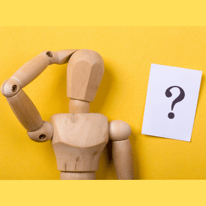 yellow background, wooden statue thinking