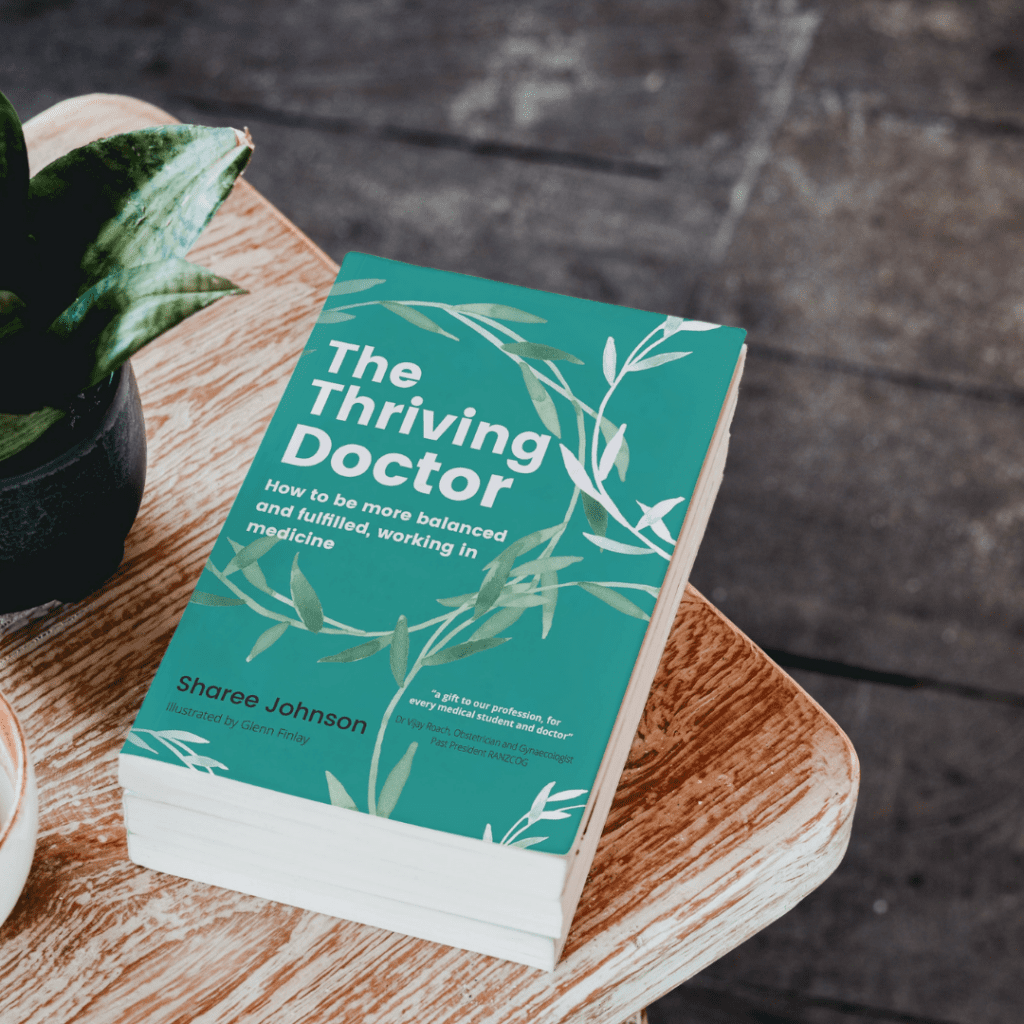 The Thriving Doctor book on a wooden table